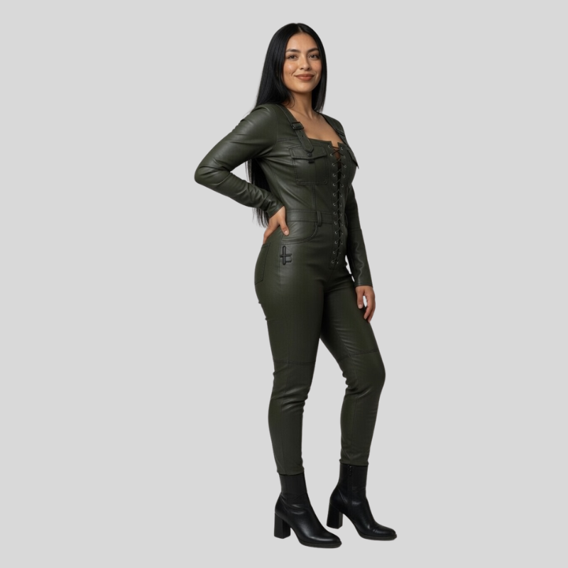 A woman modeling a dark olive green leather jumpsuit with a corset-style bodice, front buttons, and side cutouts, paired with black ankle boots, against a solid light gray background.